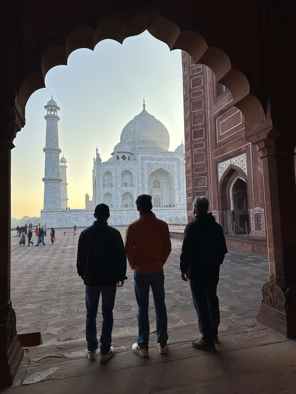 The Taj Mahal framed through a red sandstone archway