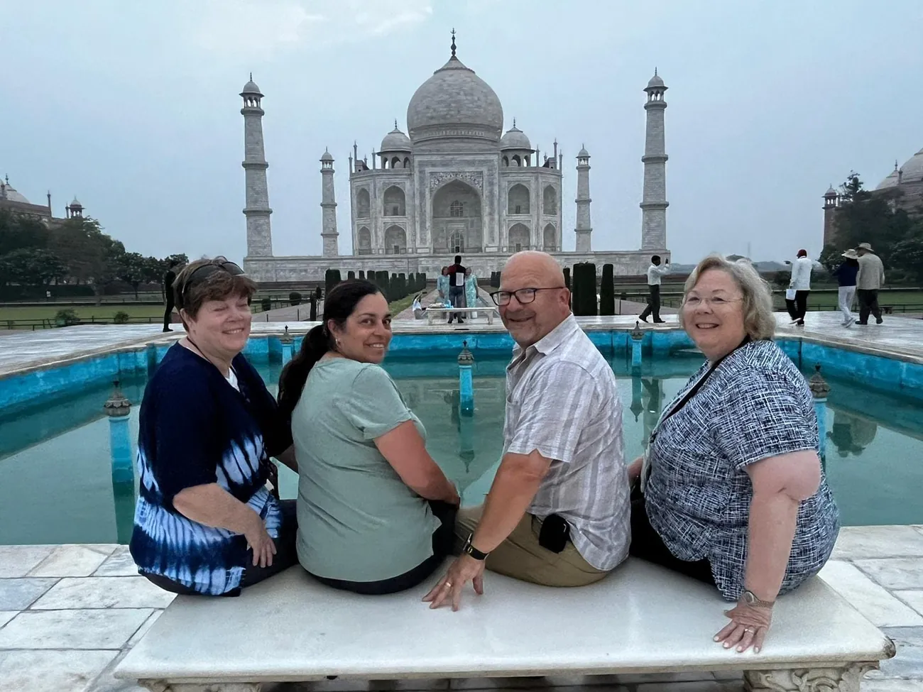 A family at the Taj Mahal reflecting pool