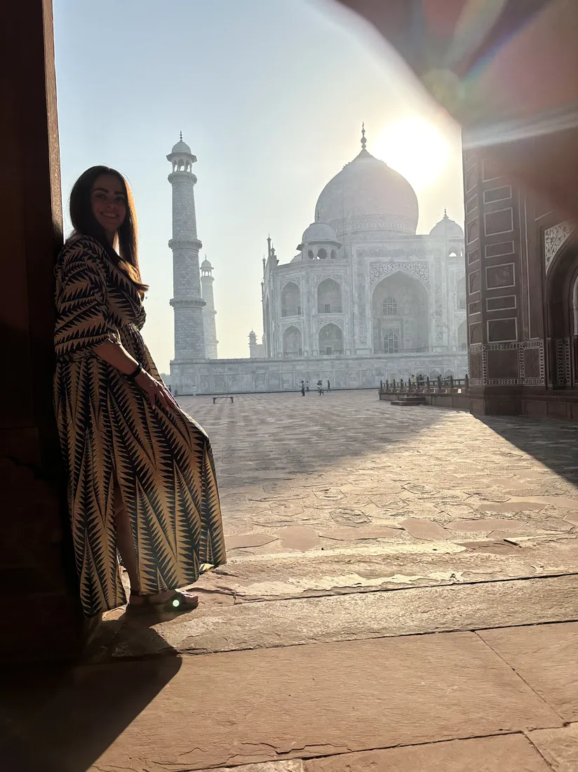 Guest with the Taj Mahal at golden hour