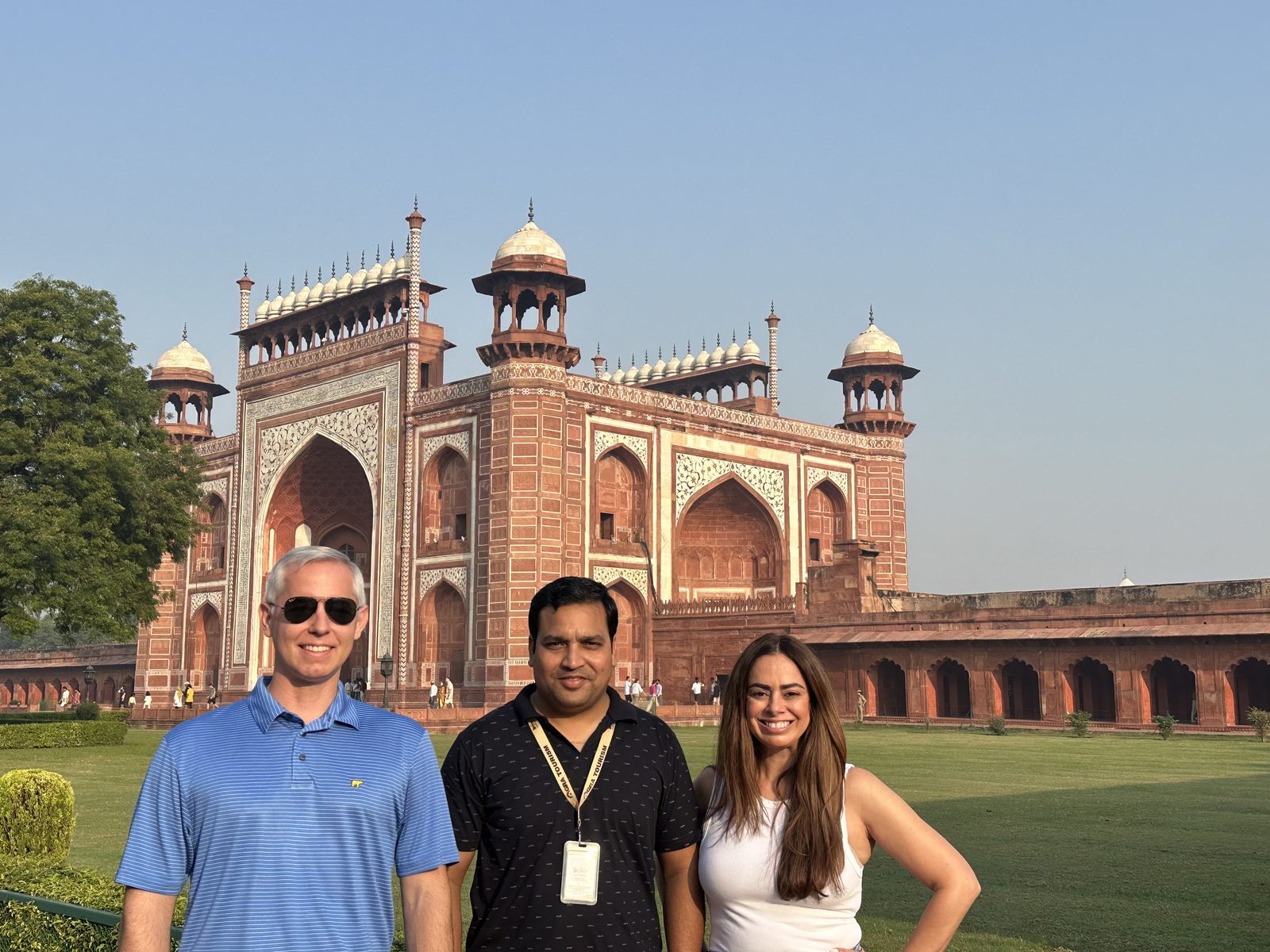 Golden Triangle travelers at the gate of Agra Fort under strong summer sun