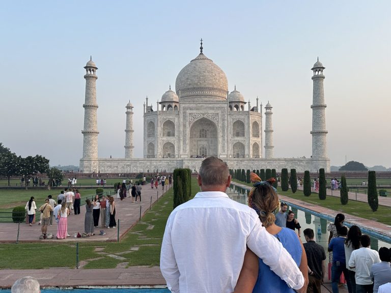 Travelers at the Taj Mahal at first light during the cool season in Agra